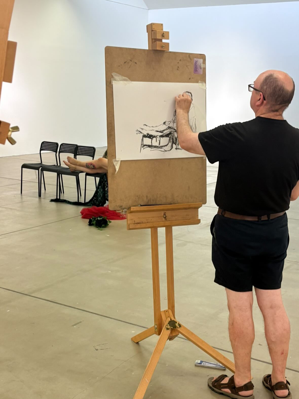 An artist at work by an easel