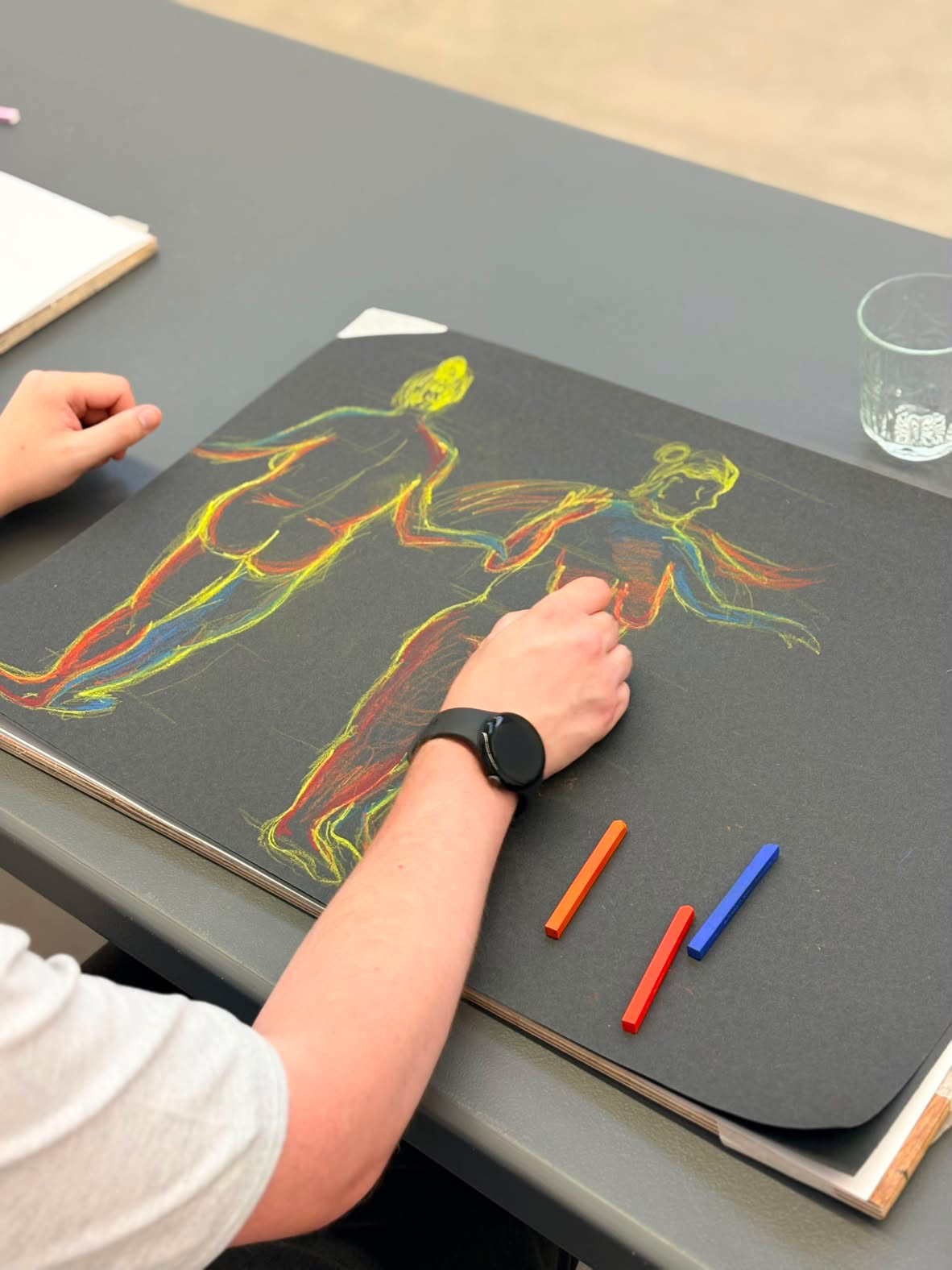 Drawing with coloured pastels on dark paper