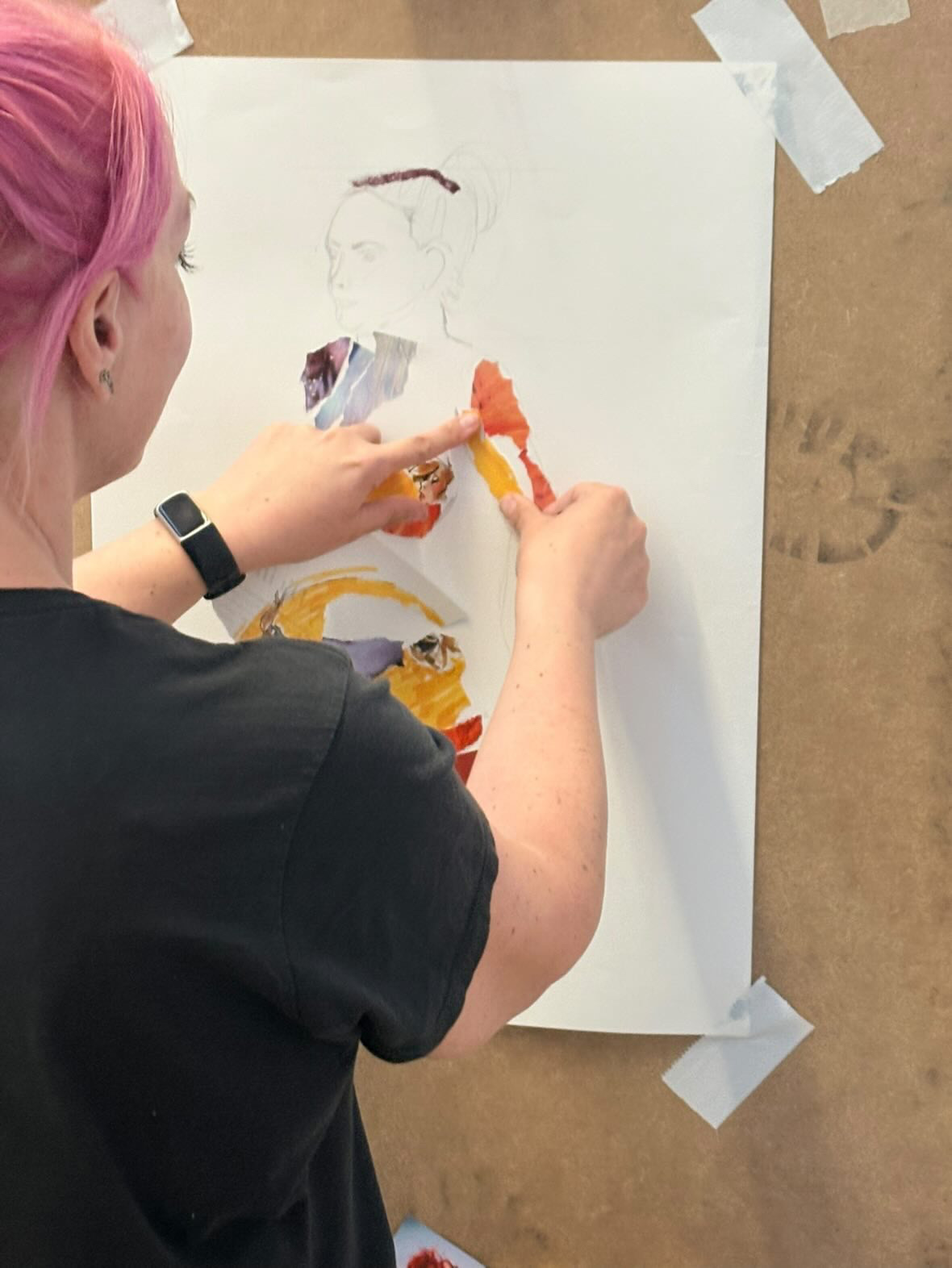 An artist's hand drawing a figure
