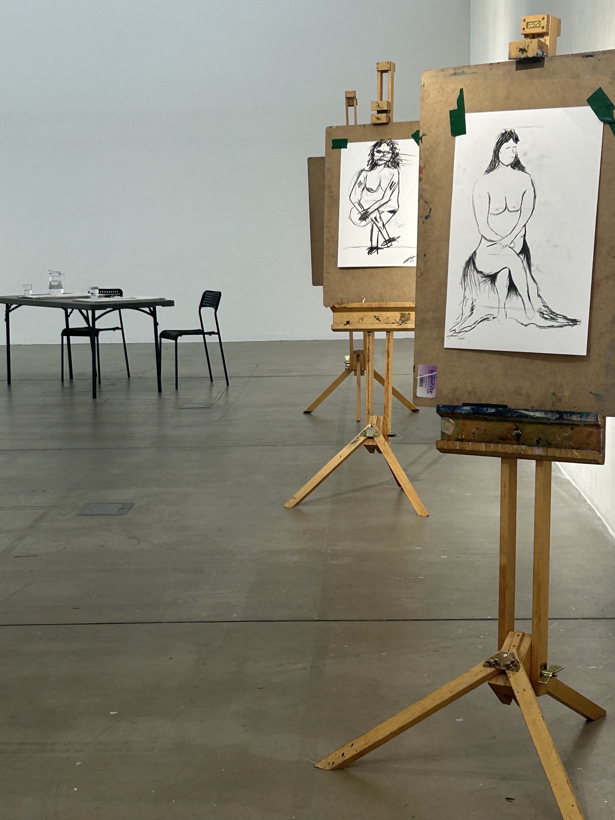 A drawing on an easel in a warm room